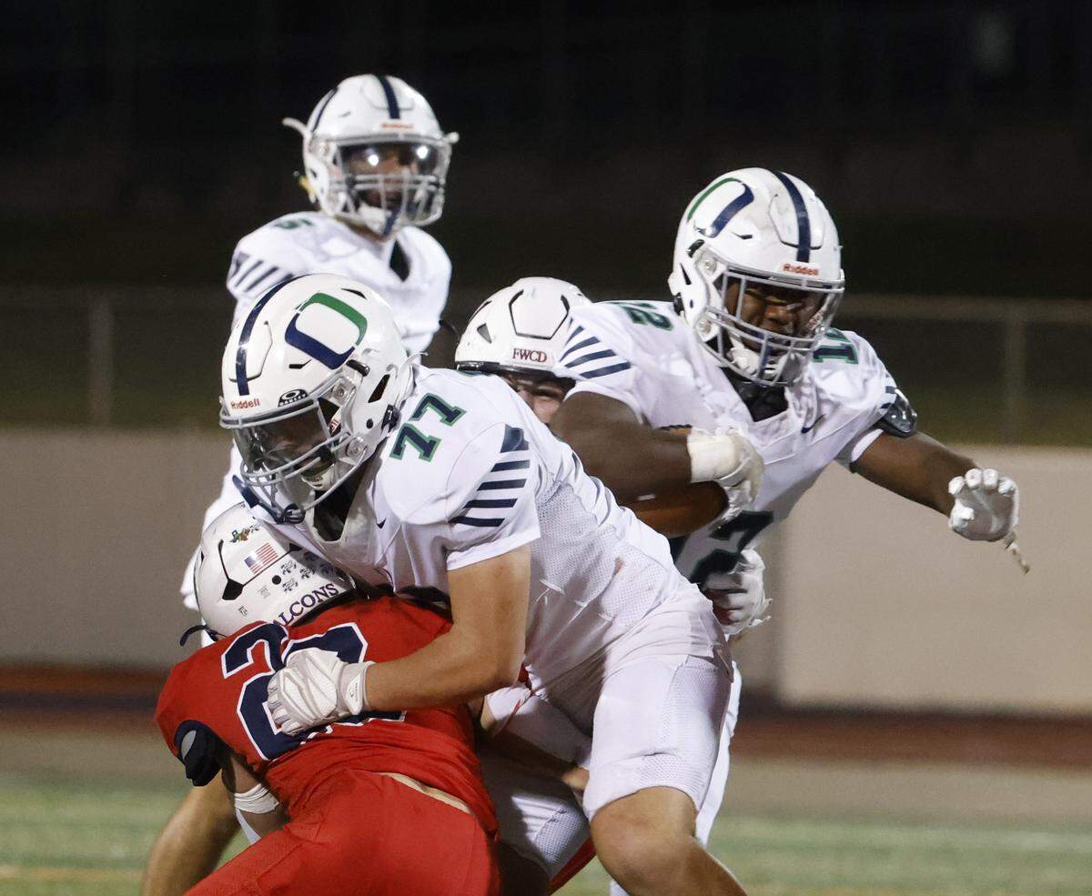 Oakridge end Joshua Dees (12) follows his lead blocker lineman Wyatt Gray (77) through the hole during the first half of the SPC 2025 3A Football Championship football game between The Oakridge School and Fort Worth Country Day at Mavericks Stadium in Arlington, Texas, Saturday Nov. 08, 2025.