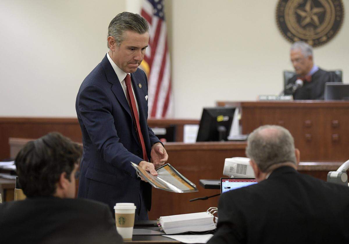 Prosecutor Bill Vassar hands some DNA photos to the defense attorneys during the capital murder trial of Latharian Merritt in Wayne Salvant’s court at Tim Curry Justice Center in Fort Worth, TX, Thursday, May 24, 2018.