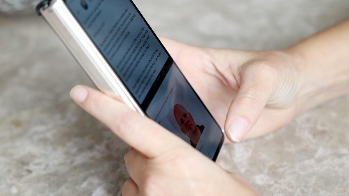 Haley Forsyth wrote a post on the social media app Nextdoor in February concerning her neighbor, Robert Rambo, whom she accuses of scamming her out of $60,000. She soon discovered there were others like her. She shows her post while scrolling through her phone at her Fort Worth home on Wednesday, May 1, 2024.