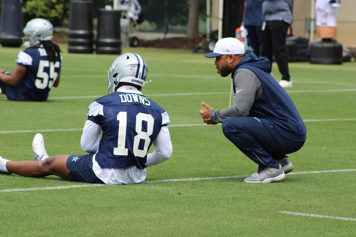 Dallas Cowboys rookie defensive back Caleb Downs and defensive coordinator Christian Parker catch up before a rookie minicamp practice at The Star in Frisco, Texas on May 1, 2026.
