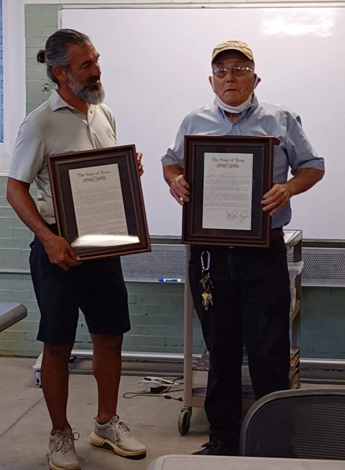 State Rep. Ramon Romero, left, presented two state resolutions on Aug. 30, 2022, at a South Hemphill Heights Neighborhood Association meeting in old Firehouse No. 10, honoring Fernando Florez, right, and his late wife Roberta Florez for their community contributions.