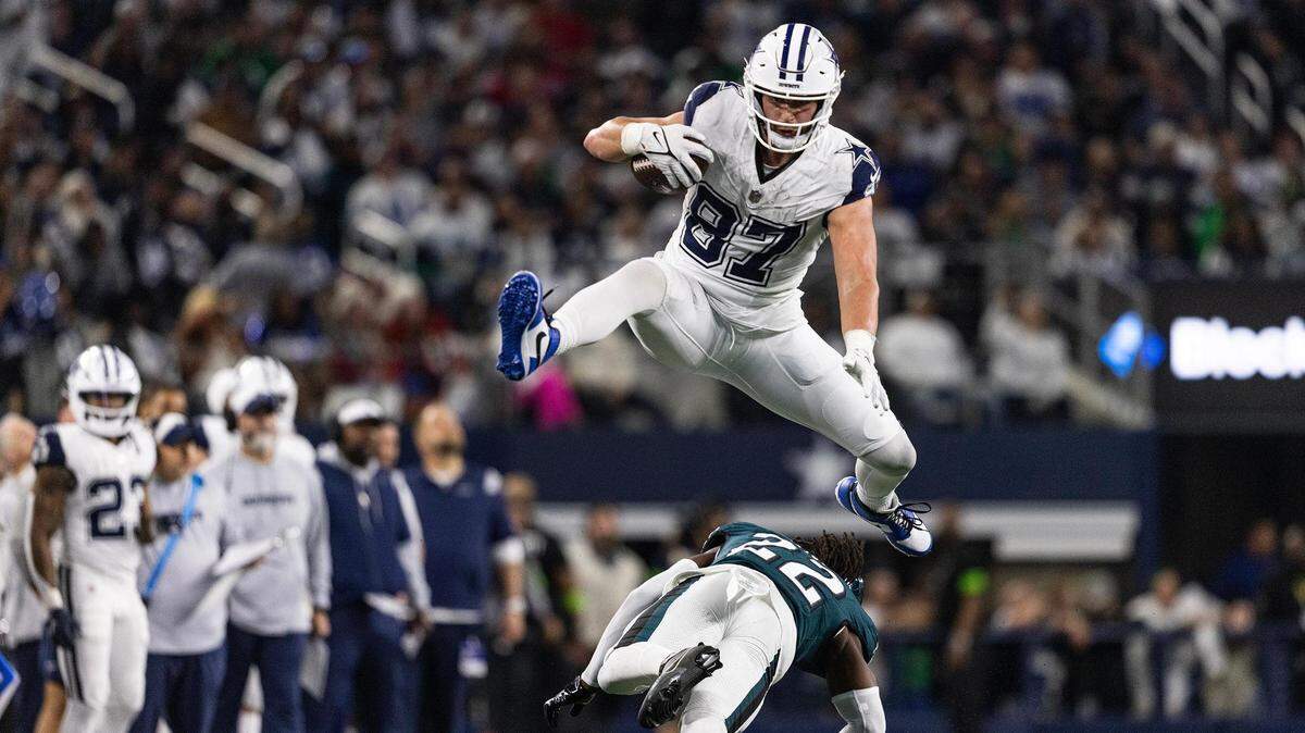 Cowboys tight end Jake Ferguson (87) hurdles Eagles cornerback Kelee Ringo (22) during the third quarter of an NFL game between the Dallas Cowboys and the Philadelphia Cowboys at AT&T Stadium in Arlington on Thursday, Dec. 10, 2023.