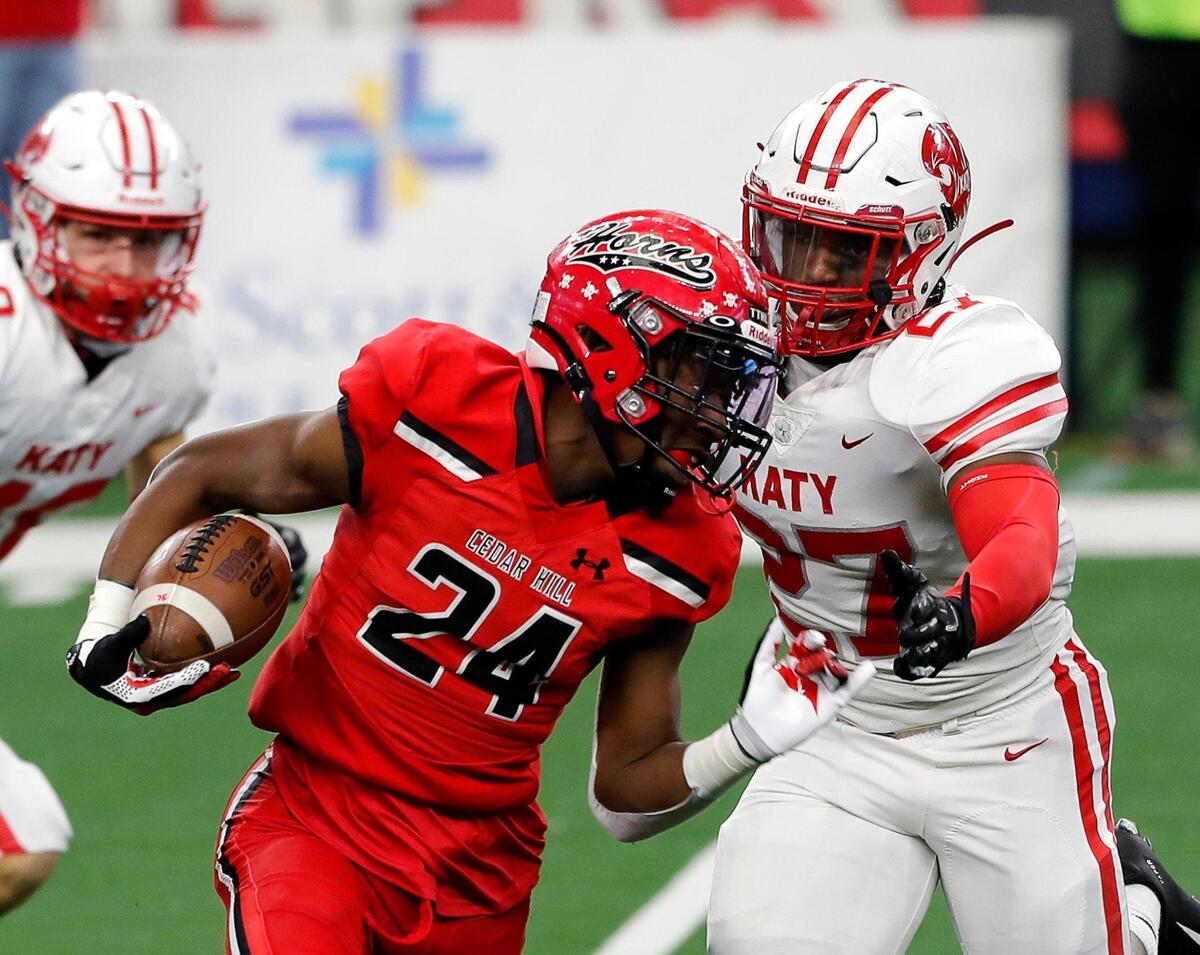 Cedar Hill free safety Keandre Jackson (24) is pursued in the backfield by Katy outside linebacker Derrick Williams (27) in the first half of the 6A D2 state title game at AT&T Stadium in Arlington, Texas, Saturday, Jan. 16, 2021. Katy led 24-0 after two frames. (Special to the Star-Telegram Bob Booth)