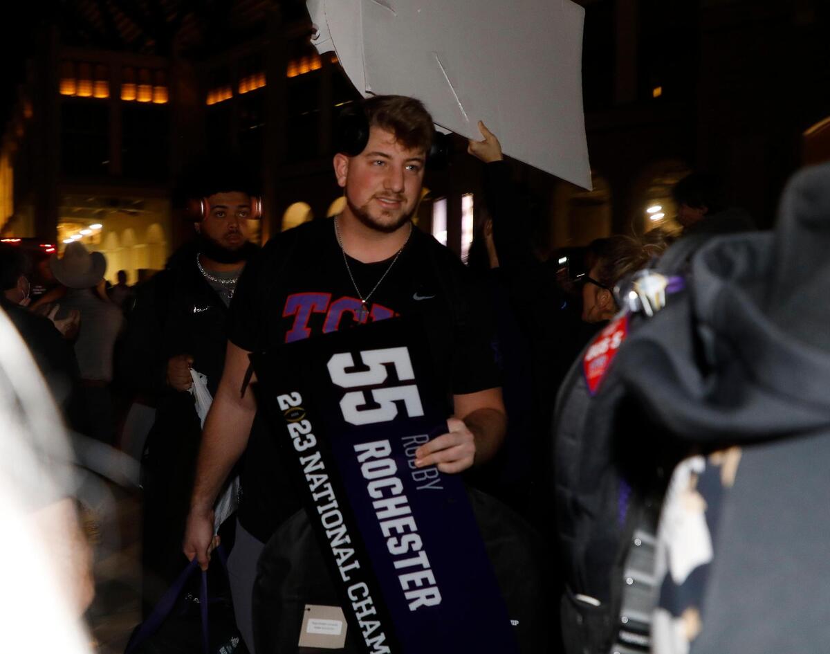 TCU offensive lineman Robby Rochester makes his way through the crowd after returning home from the CFP national championship football game to the TCU Campus in Fort Worth, Texas, Tuesday, Jan. 10, 2023.