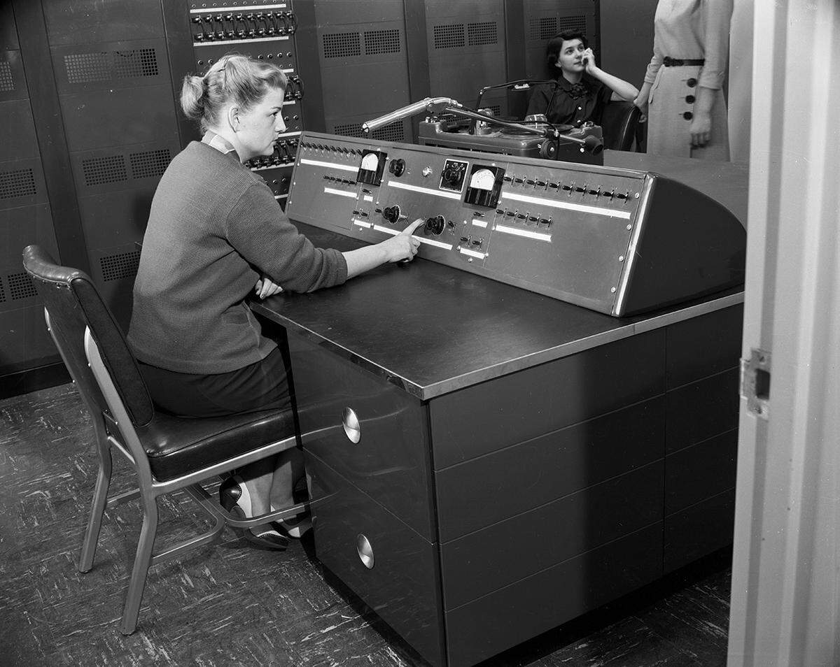 April 16, 1953: Miss Rachel Moore at the console of the public address system announcing arrival and departure of planes at Greater Fort Worth International Airport. She and five other women announced flights in English and Spanish.