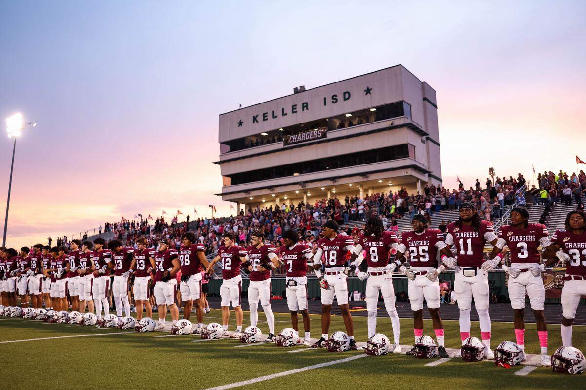 Keller Central players stand during the national anthem before their district game against L.D. Bell at Keller ISD Stadium in Keller, Texas on October 16, 2025.