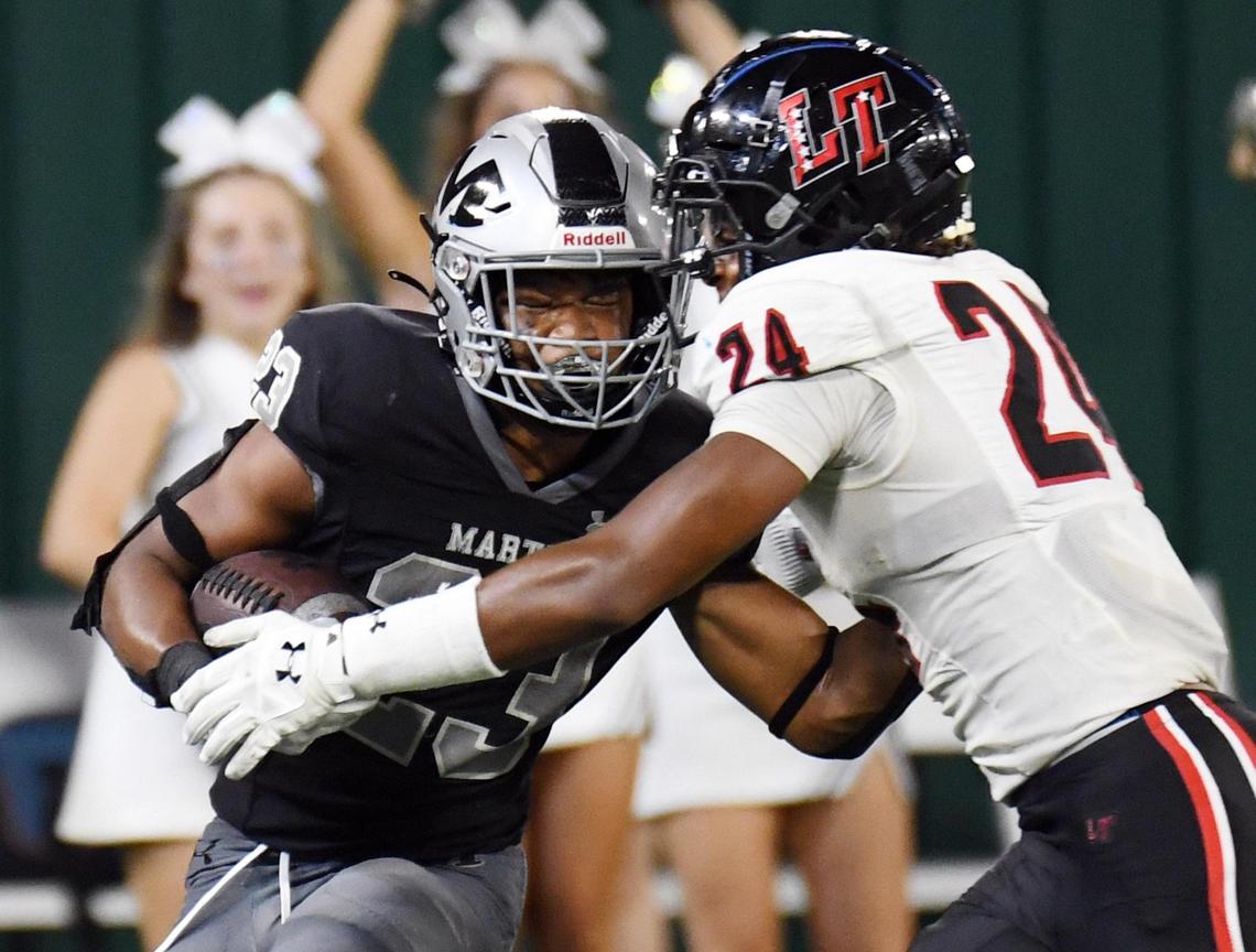 Arlington Martin’s Sergio Snider Jr. left, is hit by Lake Travis’s Markus Boswell after breaking away for first down yards in the fourth quarter of Thursday’s August 25, 2022 football game at Choctaw Stadium in Arlington, Texas. Special/Bob Haynes