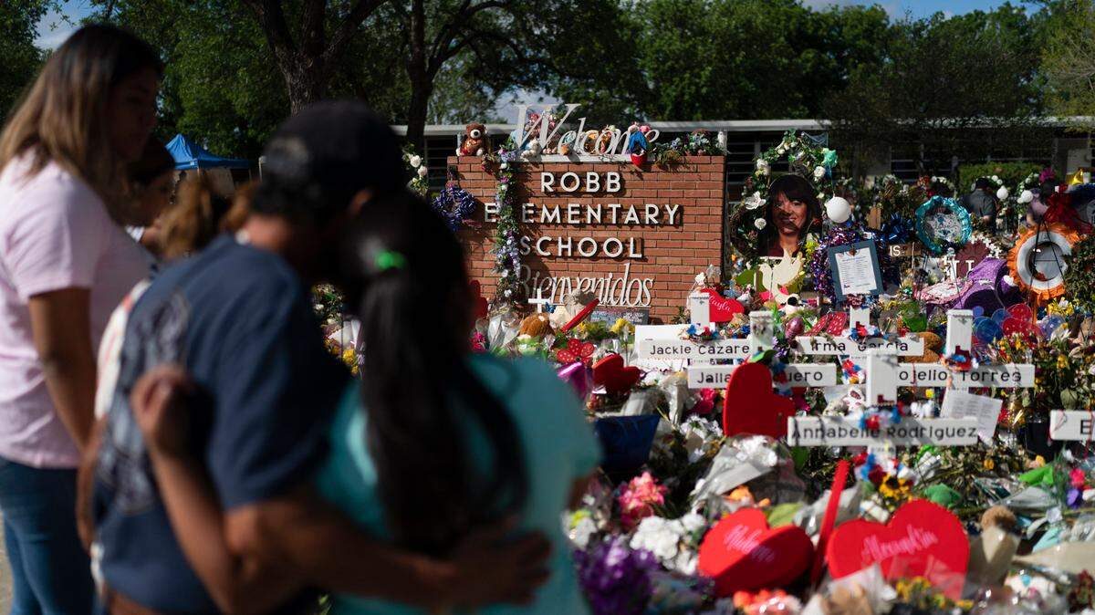 FILE - People visit a memorial at Robb Elementary School in Uvalde, Texas, on June 2, 2022, to pay their respects to the victims killed in a school shooting. A legislative committee investigating the deadly shooting at the Texas elementary school is set to hear more testimony from law enforcement officers on Monday, June 20, 2022. (AP Photo/Jae C. Hong, File)