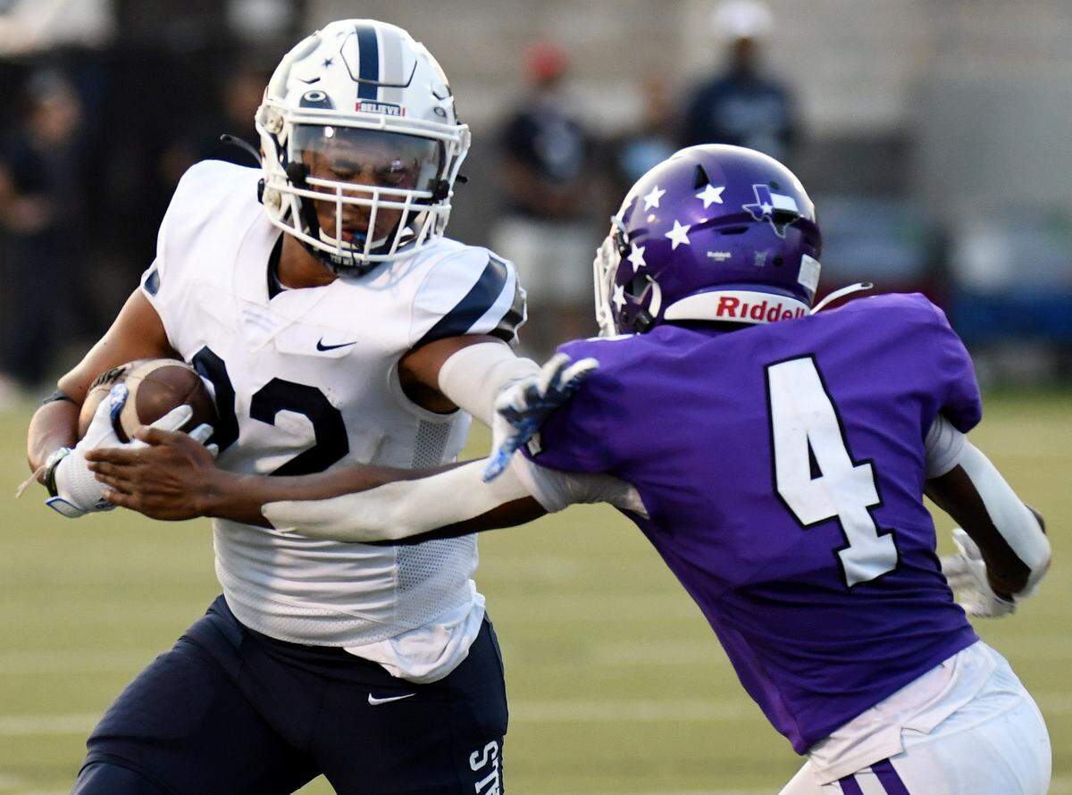 Richland’s E.J. Gipson-Smith, left, stiff-arms Paschal’s Rodrique Niyonkuru as he rushes up the field in the second quarter of their non-district football game Thursday, September 2, 2021 at the Birdville Fine Arts Athletic Complex in North Richland Hills, Texas. Special/Bob Haynes