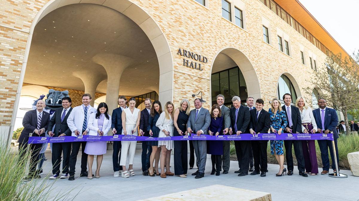 TCU officials and dignitaries prepare to cut the ribbon of the new Arnold Hall for the TCU Burnett School of Medicine in Fort Worth on Tuesday, Sept. 24, 2024.