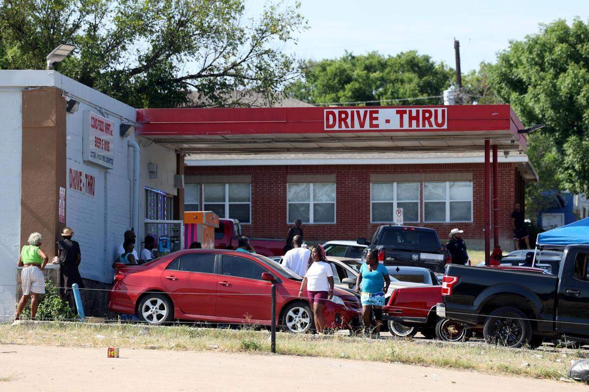 People gather for the annual Fourth of July parade in the Como neighborhood near the intersection of Diaz and Horne Streets. Three people were killed and eight wounded late Monday in a shooting during ComoFest.