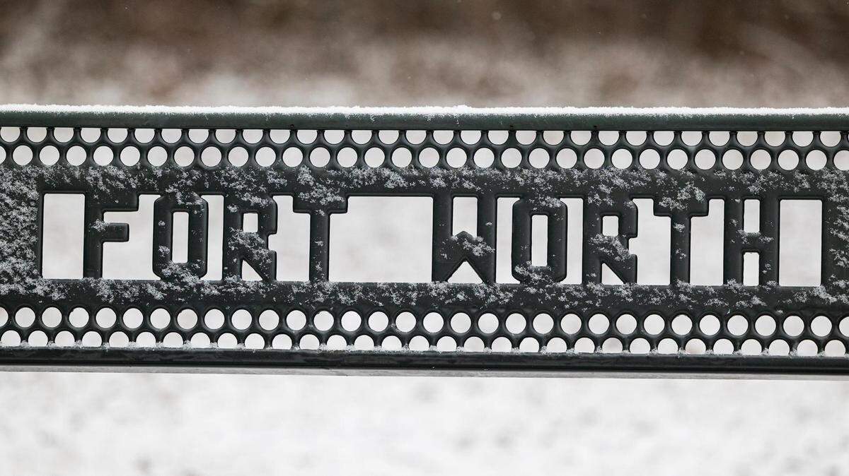 A snow-covered bench at Oakmont Park in Fort Worth on Monday, Jan. 15, 2024.