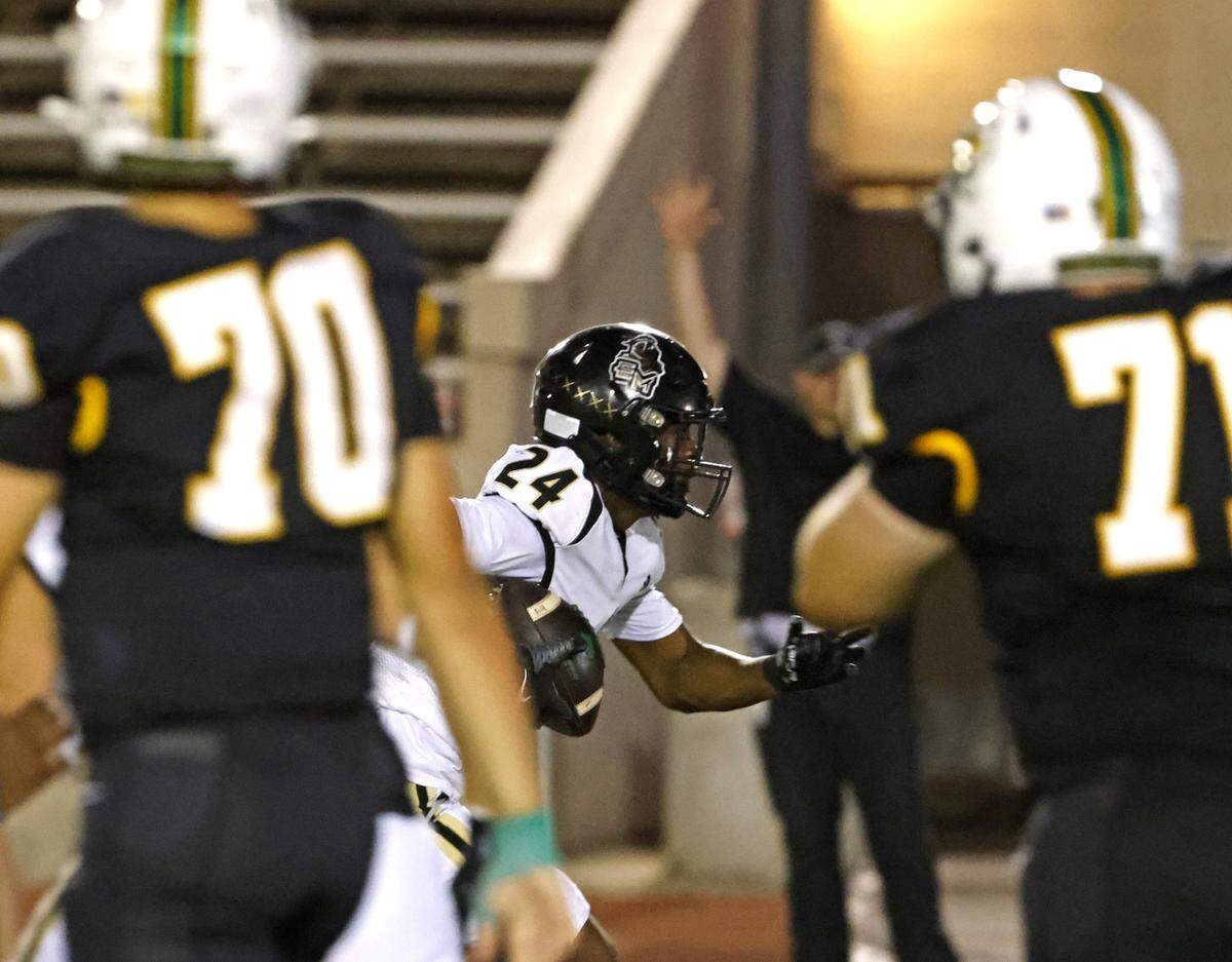Eagle Mountain defenisve back Mamoud Hussein (24) picks six in traffic during the first half of a UIL football game between Eagle Mountain and Benbrook at Farrington Field in Fort Worth, Texas, Friday, Sept. 26, 2025.