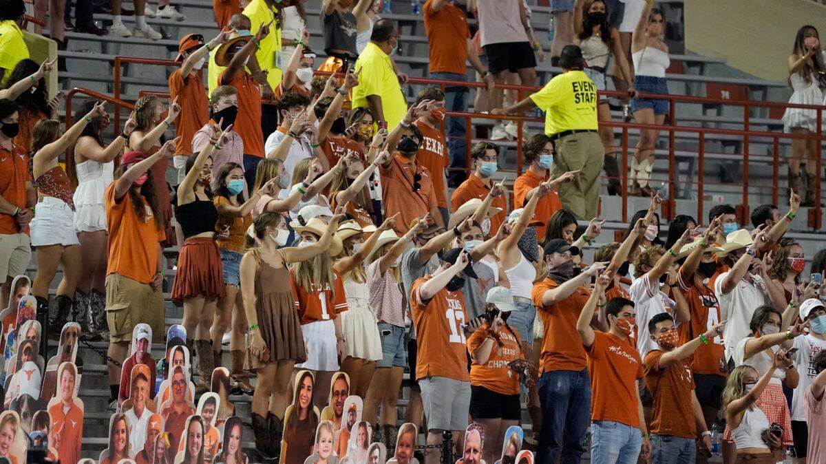 In this Saturday, Sept. 12, 2020, file photo, fans join in singing “The Eyes of Texas” after Texas defeated UTEP 59-3 in Austin. The Texas NAACP, UT chapter and anonymous students have filed a civil rights complaint over the continued playing of the alma mater that premiered at a minstrel show in the early 1900s.
