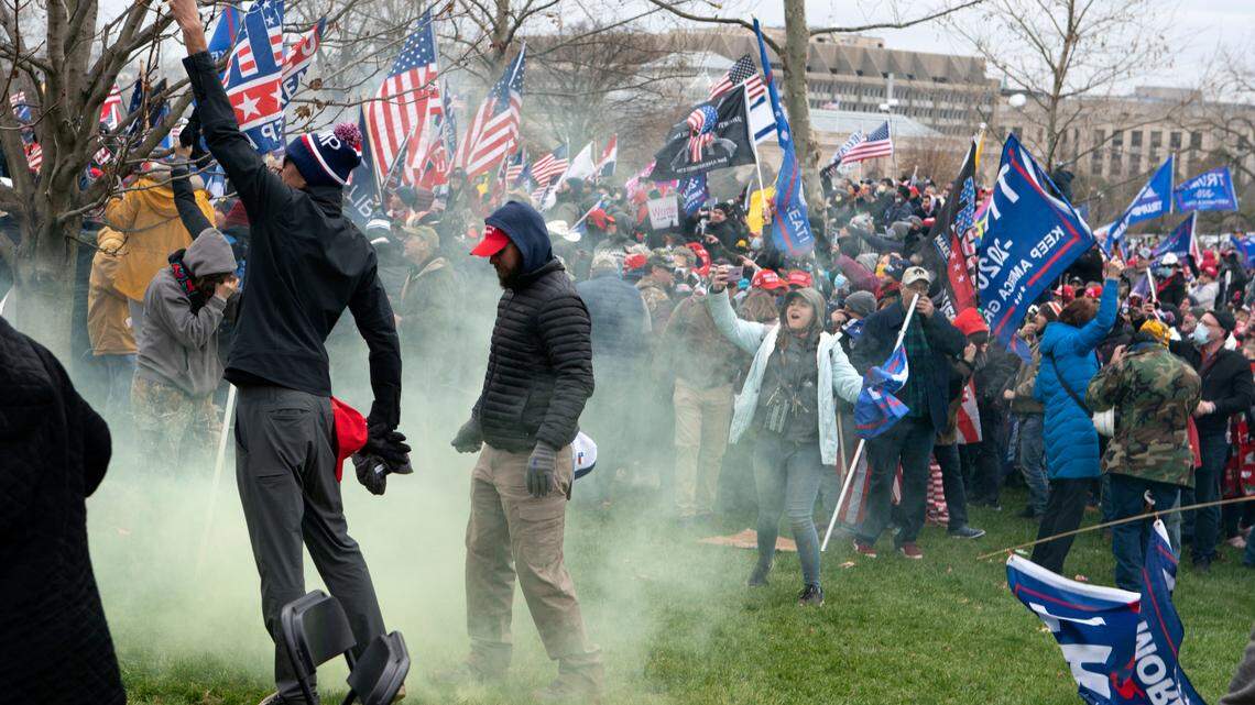 Supporter of President Donald Trump protest as U.S. Capitol Police officers shoot tear gas at demonstrators outside of the U.S. Capitol on Wednesday, Jan. 6, 2021, in Washington. (AP Photo/Jose Luis Magana)