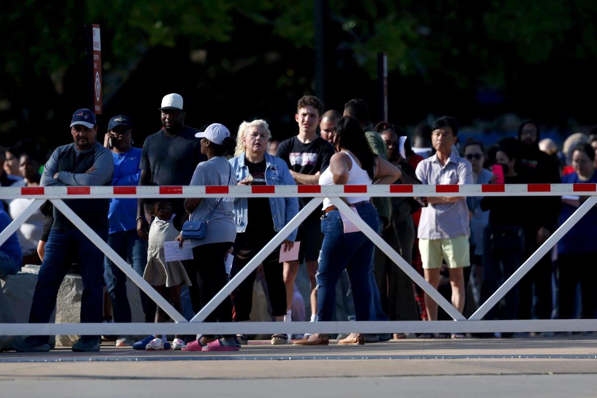 Parents and family line up outside Arlington ISD Athletic Center to be reunited with students following a shooting outside of Bowie High School in Arlington on Wednesday, April 24, 2024.