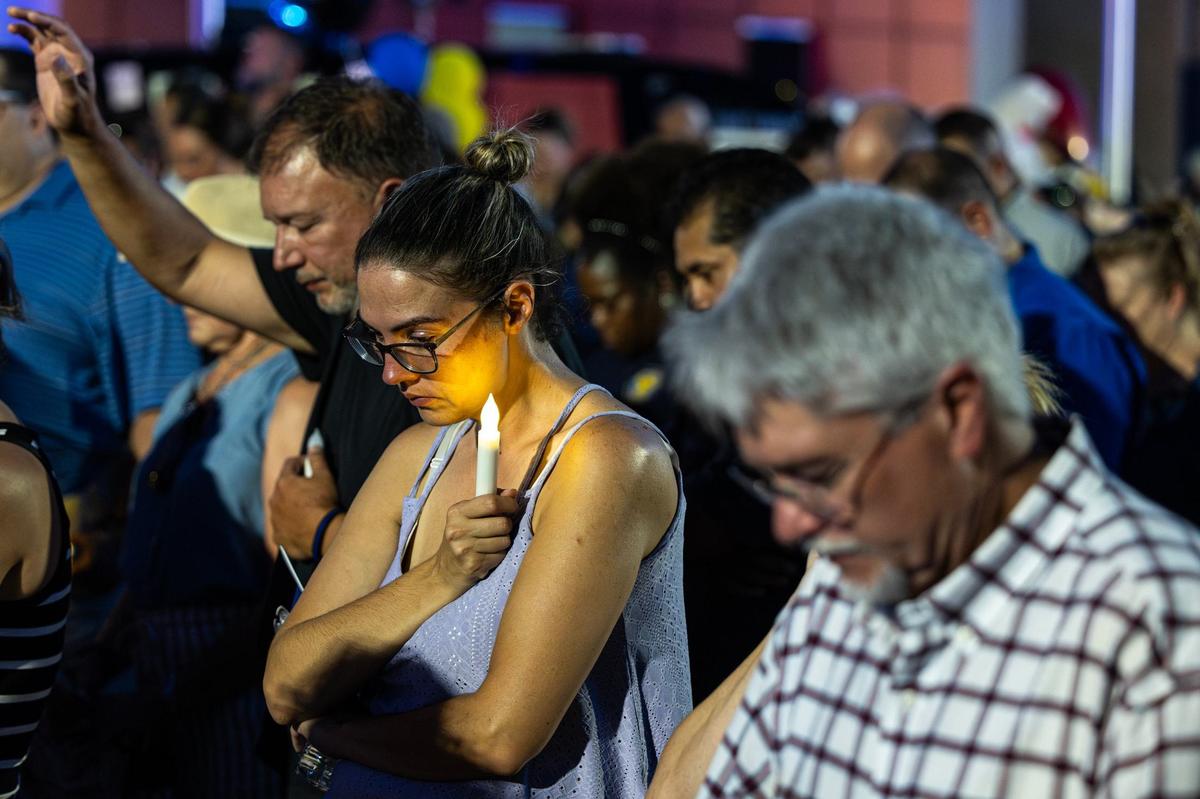 Community members pray during a vigil on Aug. 14, 2024, at the department’s South Division headquarters. Fort Worth Police Department Sgt. Billy Randolph was struck by a car while working a crash scene on an I-35W exit ramp near Sycamore School Road.
