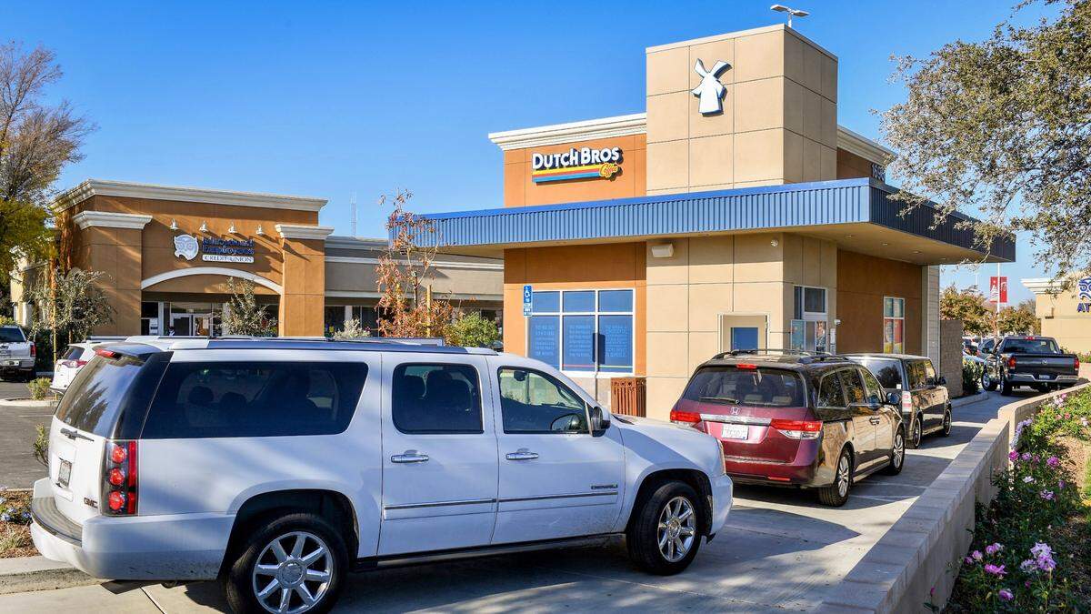 A Dutch Bros. Coffee restaurant has a colorful exterior and atmosphere.