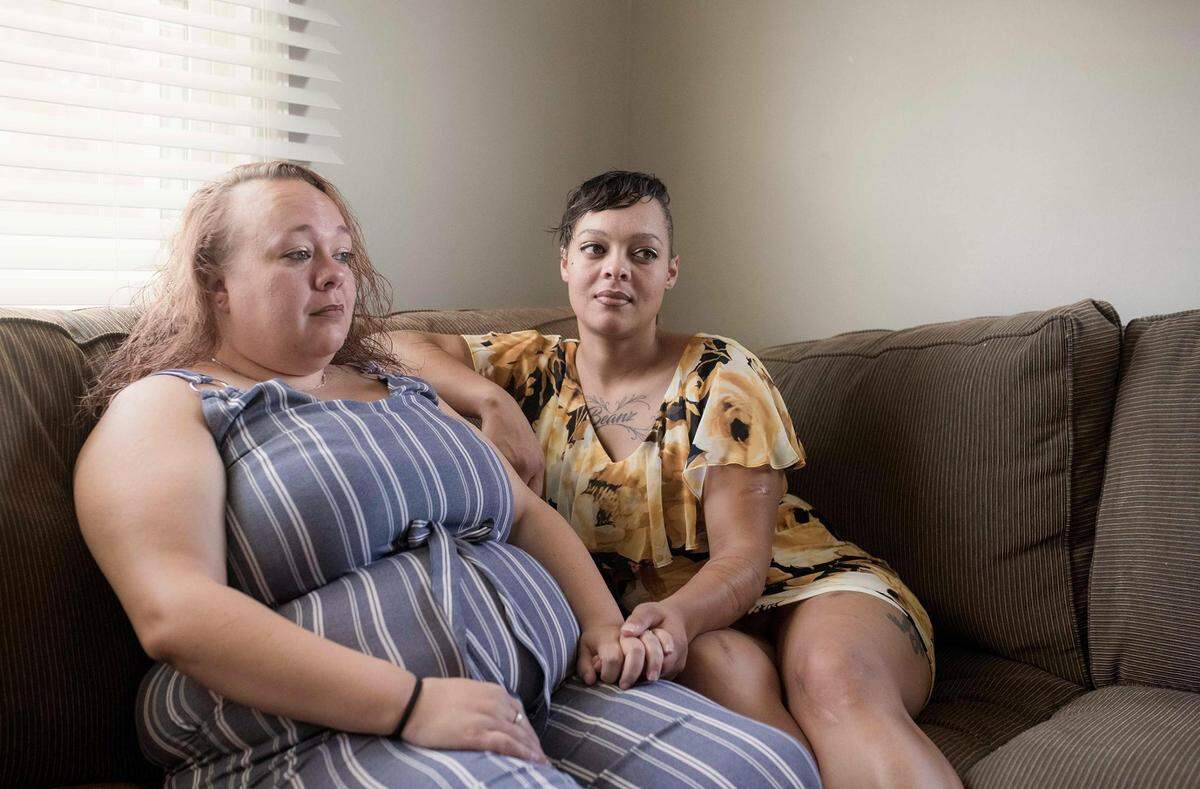 Chantel Dudley (right) sits with her sister, Stephanie McGee, while at her home in Kingsport, Tennessee., on July 23.