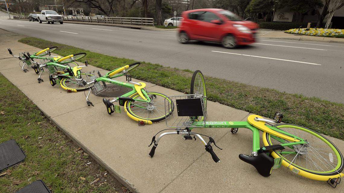 A perfect example of the bike problem in Dallas, where a group of LimeBikes lay overturned on a side walk along Lemmon Avenue.