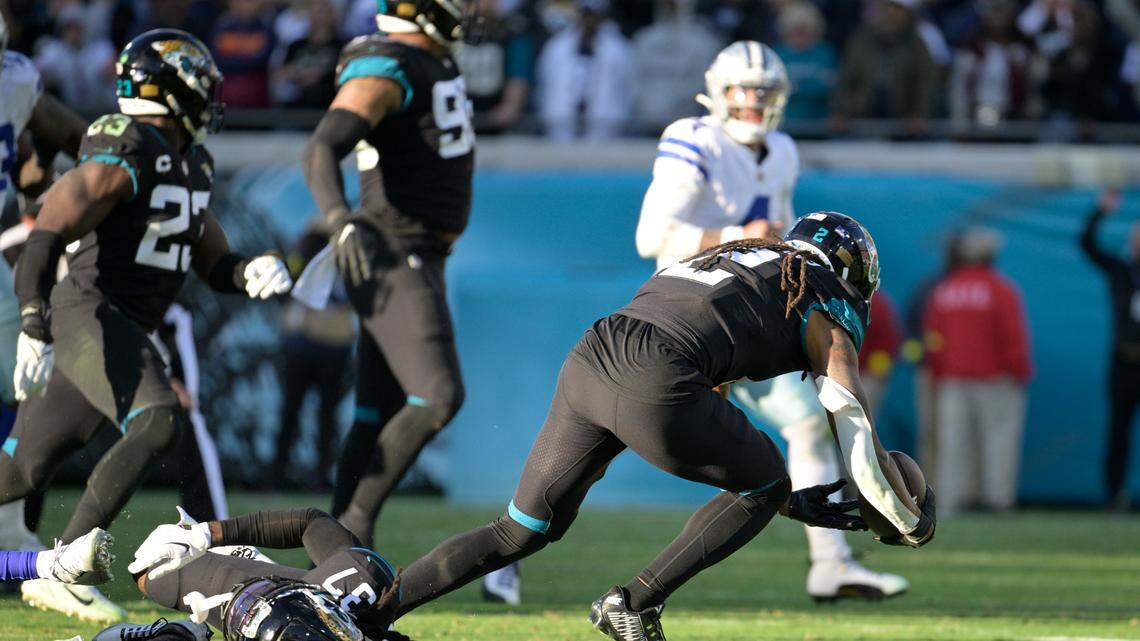Jacksonville Jaguars safety Rayshawn Jenkins (2) intercepts a pass and runs in for a touchdown to win against the Dallas Cowboys during overtime ion Sunday in Jacksonville.