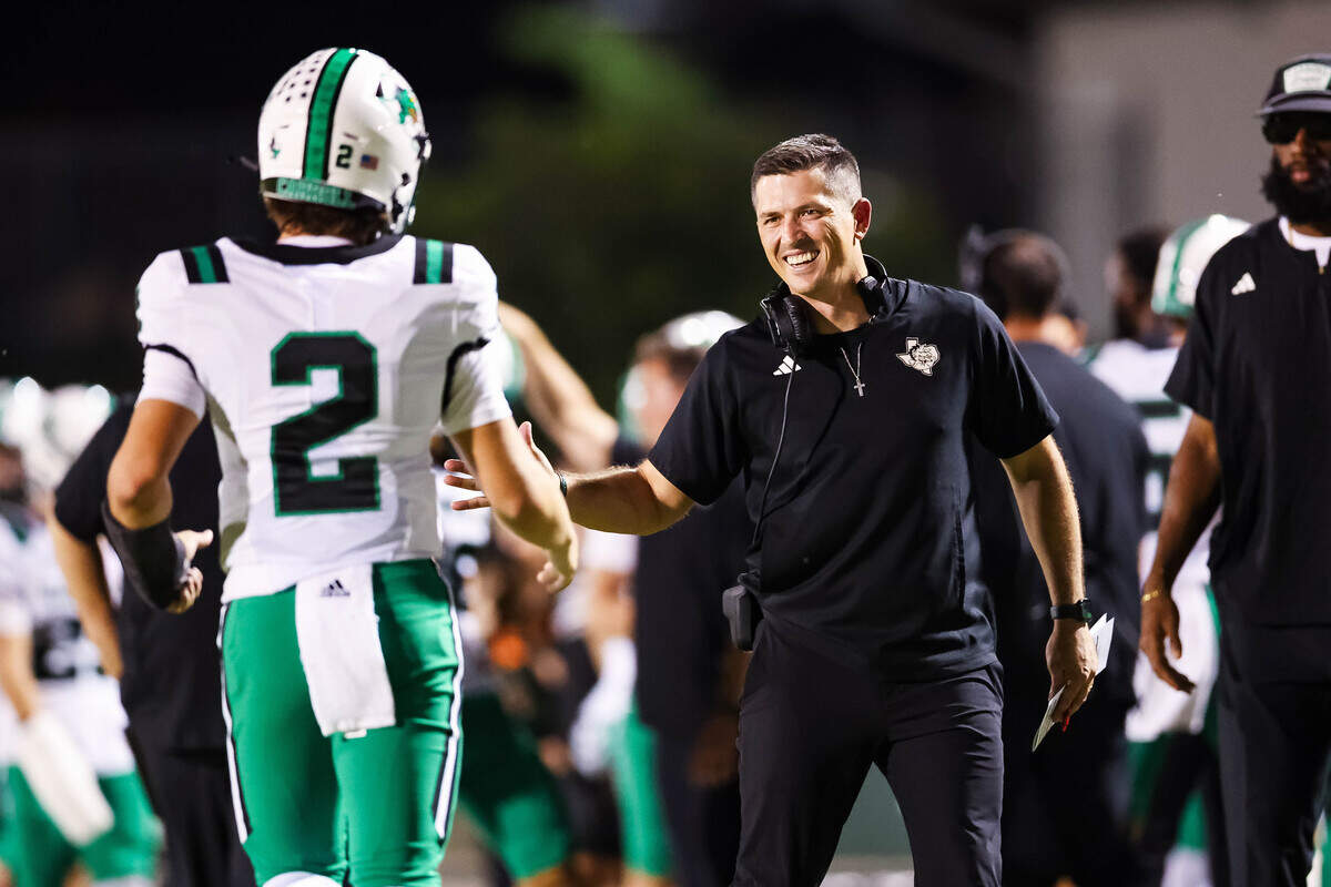 Southlake head coach Riley Dodge high-fives quarterback Angelo Renda after a touchdown during a district matchup between Southlake Carroll and Timber Creek at Keller ISD Stadium on Thursday Sept. 25, 2025.