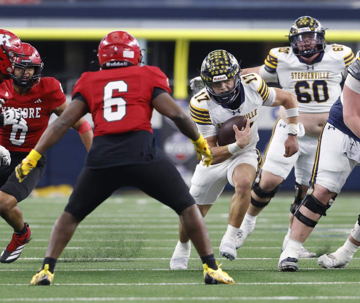 Stephenville quarter back Trot Jordan (17) finds running room in the middle against Kilgore linebacker David McGowan (6) during the first half of the UIL Class 4A Division I championship game on Friday Dec. 19, 2025 at AT&T Stadium in Arlington, Texas.