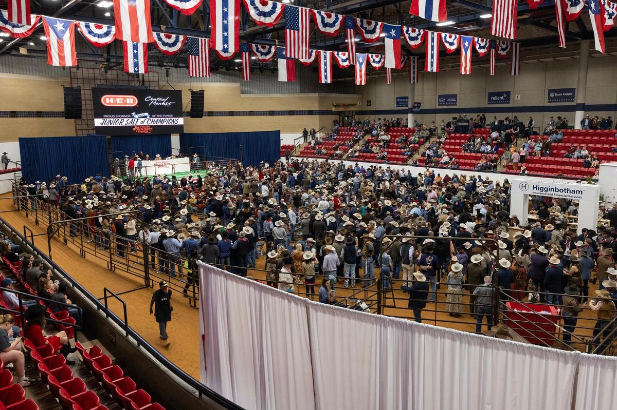 Event attendees gather by the auction stage for the Auction of Champions for the Fort Worth Stock Show & Rodeo in the Wyatt Arena on Saturday, Feb. 8. 2025.