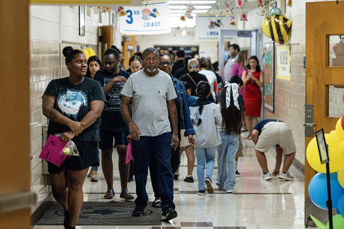 Parents and students walk through the hallways on the first day of instruction at Mary Louise Phillips Elementary School in Fort Worth on Tuesday, Aug. 12, 2025.