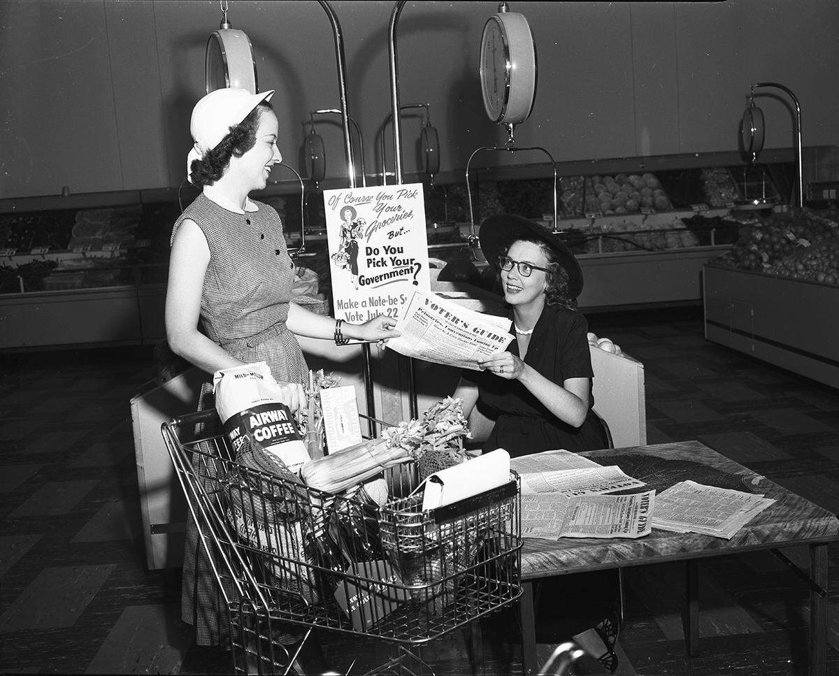 July 17, 1950: Mrs. Harry N. Harris, right, hands a Voters Guide to Mrs. W.S. Lorimer Jr. at the booth operated by the Fort Worth League of Women Voters at the Safeway store, 3614 Camp Bowie (now the site of a CVS). Posters have been distributed to all Safeway and A&P stores, and to beauty parlors and shopping centers.
