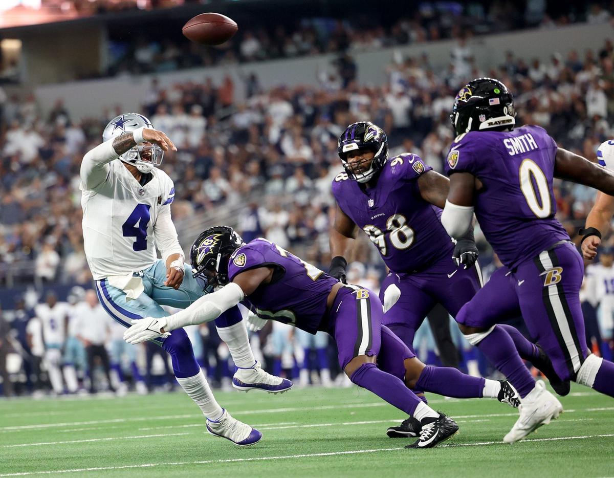 Dallas Cowboys quarterback releases the ball while under pressure from the Baltimore Ravens defense on Sunday at AT&T Stadium in Arlington.