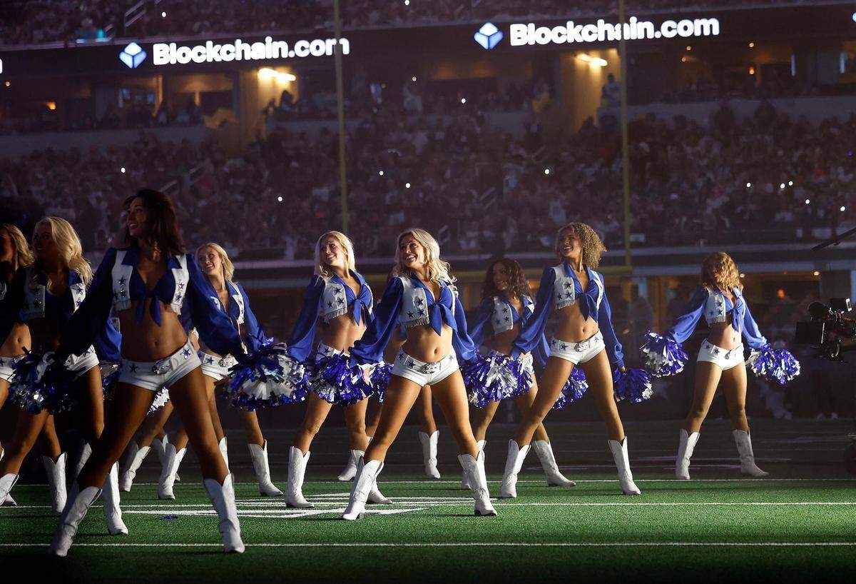 The Dallas Cowboys Cheerleaders perform with Dolly Parton during the Dallas Cowboys’ halftime show to kickoff the Red Kettle Campaign on Thursday, November 23, 2023, at AT&T Stadium in Arlington.