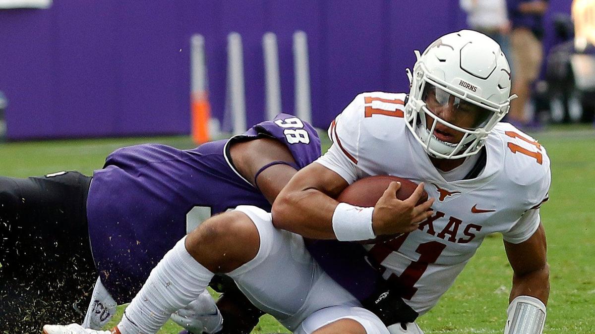 TCU defensive end Dylan Horton (98) brings down Texas quarterback Casey Thompson (11) in the first half of Saturday’s game. Horton picked up two sacks in the Horned Frogs’ loss.