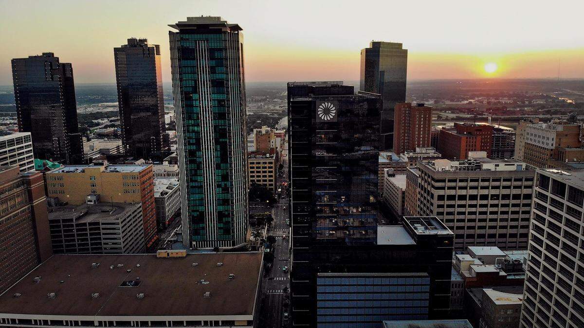 The sun rises behind downtown Fort Worth’s skyline on Friday, September 9, 2022.