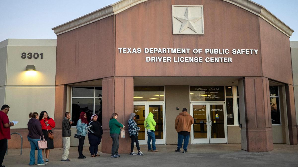 A line of people forms outside of the Texas Department of Public Safety Driver License Mega Center in Fort Worth in October. With residents waiting up to months for a scheduled appointment, some people choose to arrive early and spend their morning waiting for a walk-in.
