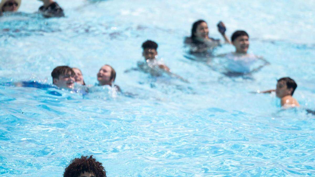 People wade in a pool waiting for the waves to hit in a 2022 archive photo at Hurricane Harbor in Arlington.