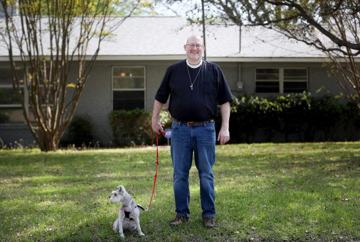 Rev. Dr. Robert Pace walks his dog, Scout, outside of his home in Brenbook on Thursday, March 26, 2020. Pace was the first known case of COVID-19 in Tarrant County. He has recovered and received his second negative test on March 19.