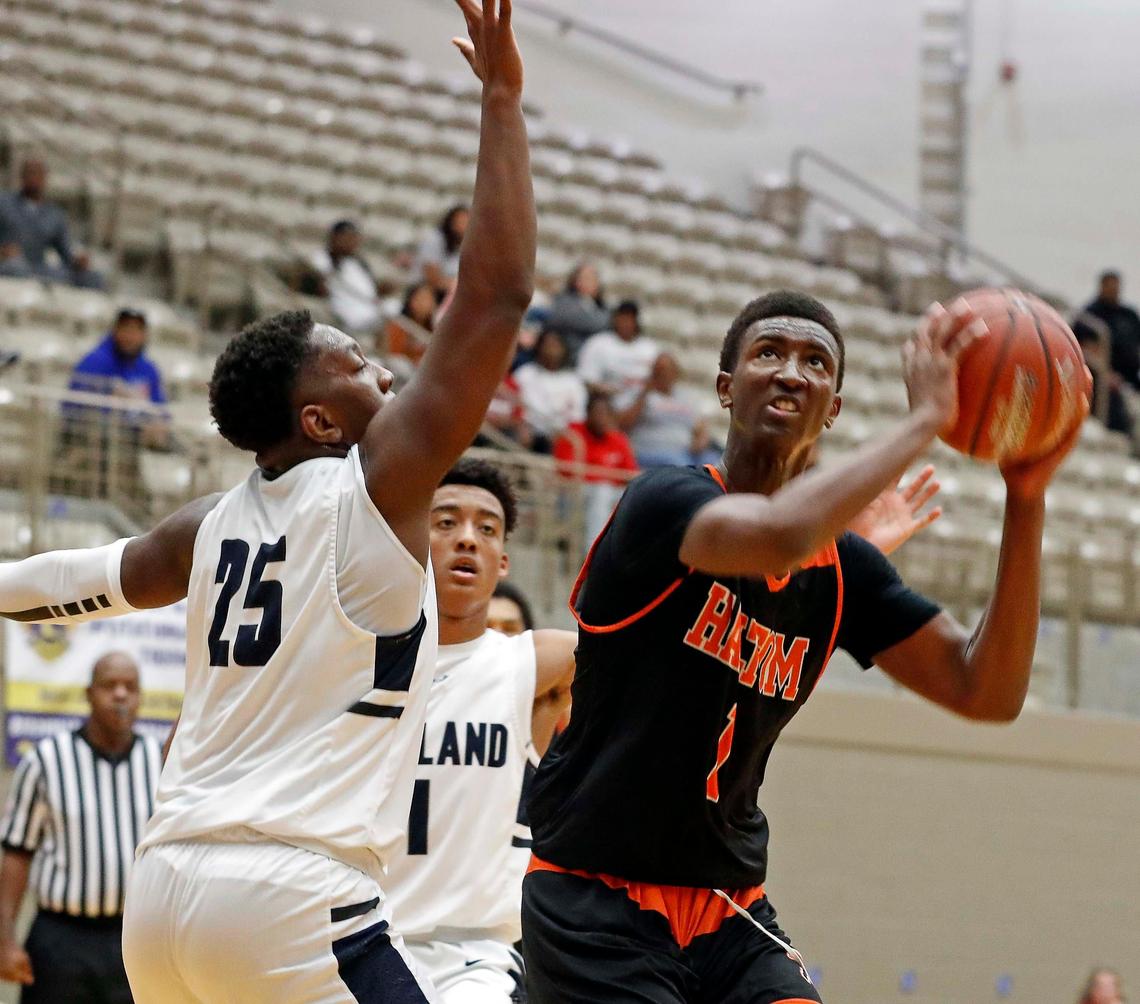 Haltom forward Paul Bizimana (1) gets a look defended by Richland forward Kendle Arnold (25) in the second quarter of the Lions Club Girls and Boys Holiday Basketball Tournament boys championship game at W. G. Thomas Coliseum in Haltom City, Texas, Saturday, Dec. 07, 2019. Bizimana earned MVP for the tournament. He scored 40 points and 10 re-bounds for a double double in this game. Richland led 21-12 after the first quarter. Richland led 41-36 at the half. (Special to the Star-Telegram Bob Booth)
