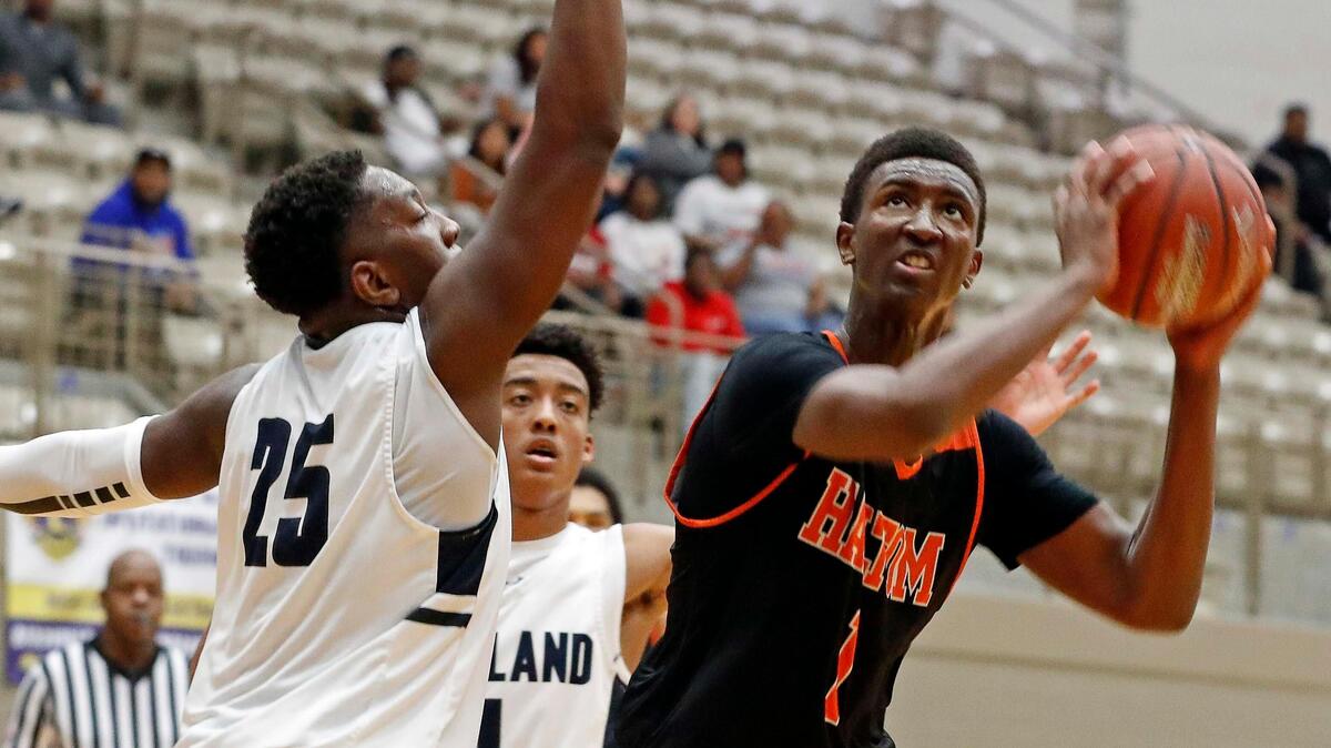 Haltom forward Paul Bizimana (1) gets a look defended by Richland forward Kendle Arnold (25) in the second quarter of the Lions Club Girls and Boys Holiday Basketball Tournament boys championship game at W. G. Thomas Coliseum in Haltom City, Texas, Saturday, Dec. 07, 2019. Bizimana earned MVP for the tournament. He scored 40 points and 10 re-bounds for a double double in this game. Richland led 21-12 after the first quarter. Richland led 41-36 at the half. (Special to the Star-Telegram Bob Booth)