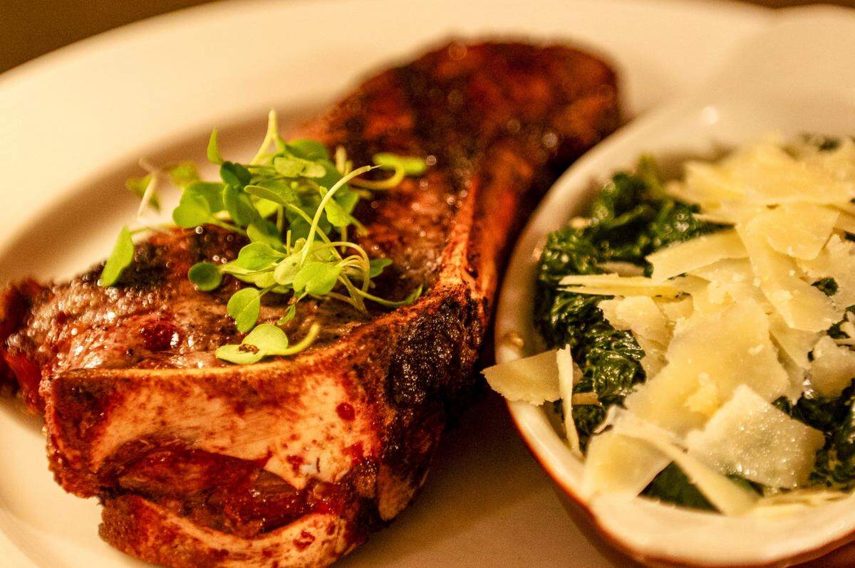 A Kansas City strip steak and parmesan creamed spinach at the Golden Ox in Kansas City Oct. 26, 2023. The steakhouse claims to be the home of the Kansas City strip