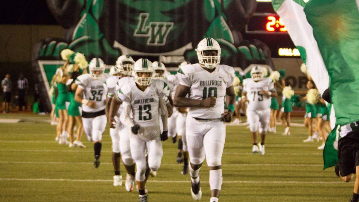 Lake Worth football runs out on the field during a recent game.