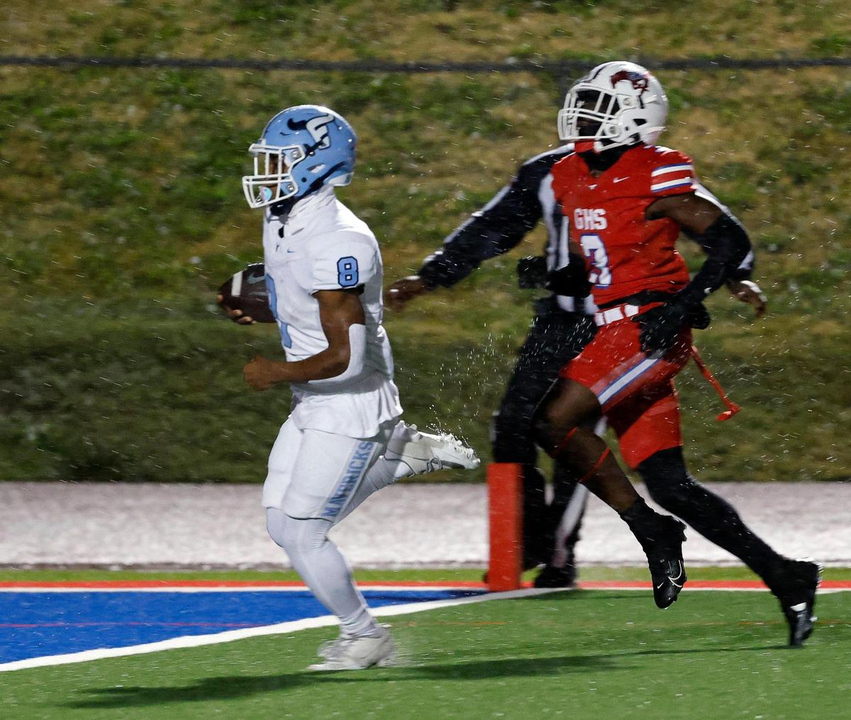 Emerson running back Kameron Lockhart (8) steps into the end zone ahead of Grapevine defensive back Dereon Burns (3) in the first half of a UIL 5A D2 football playoff game at Mustang Panther Stadium in Grapevine, Texas, Thursday, Nov. 09, 2023.