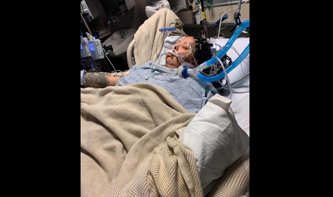 Sandra Castro, 36, lies in a coma with an intubation tube going down her throat. She has been hospitalized several times since she came down with the coronavirus in late March, even after she tested negative.