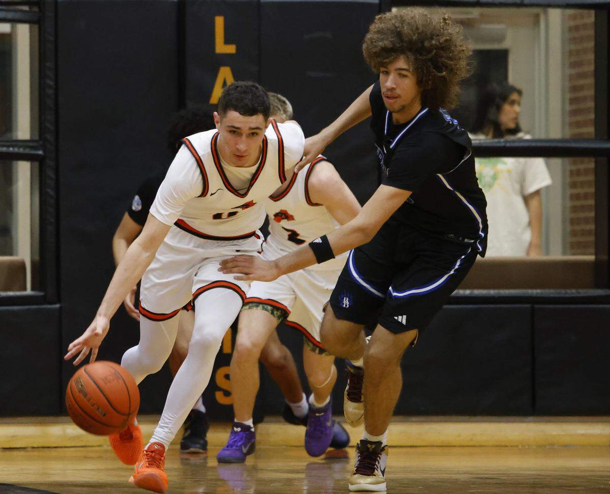 Brewer center Jayden Johnson (30) reaches in on Aledo guard Enrique Pacheco (0) during the second half of a UIL boys basketball game at Aledo High School in Aledo, Texas, Friday Feb. 13, 2026.