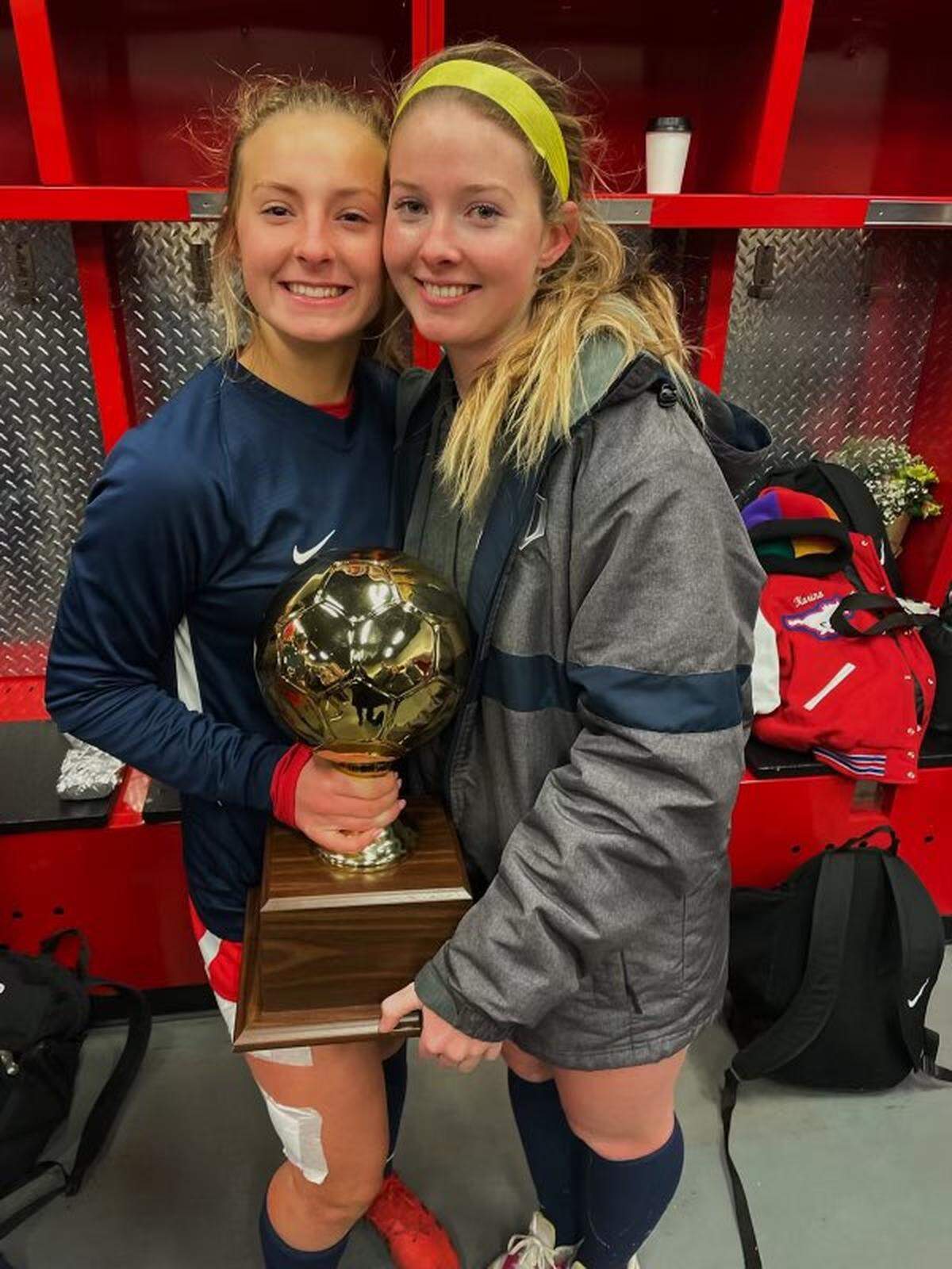 Grapevine’s Sydney and Caroline Martin pose with the district champion. The Mustangs clinched a state berth for the fifth time in the last seven postseasons. (Courtesy)