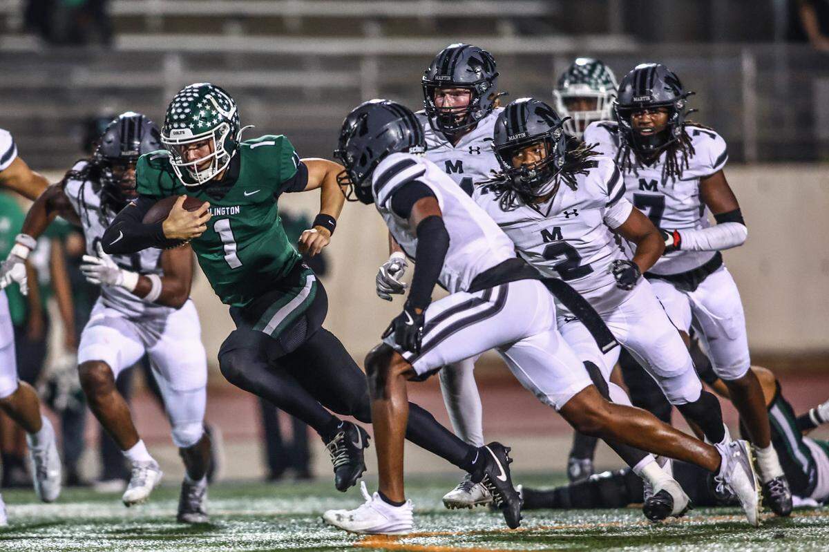 Arlington quarterback Coleman Cravens runs for a first down in a 49-31 victory over Martin in 2024.