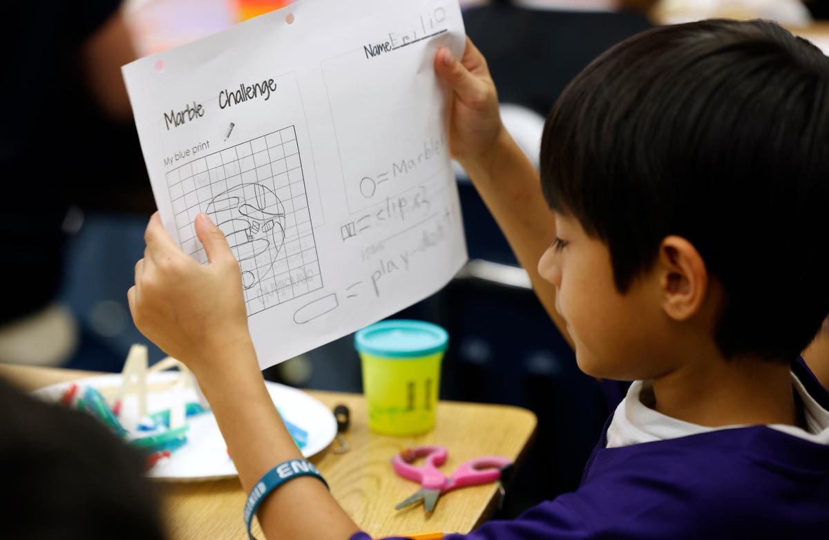 Emilio Sanchez explains his blueprint for a marble maze to the rest of the class during a summer enrichment camp at Rufino Mendoza Elementary School on June 12 in Fort Worth. The four-day camp had various creative and enriching activities for students identified as gifted and talented.