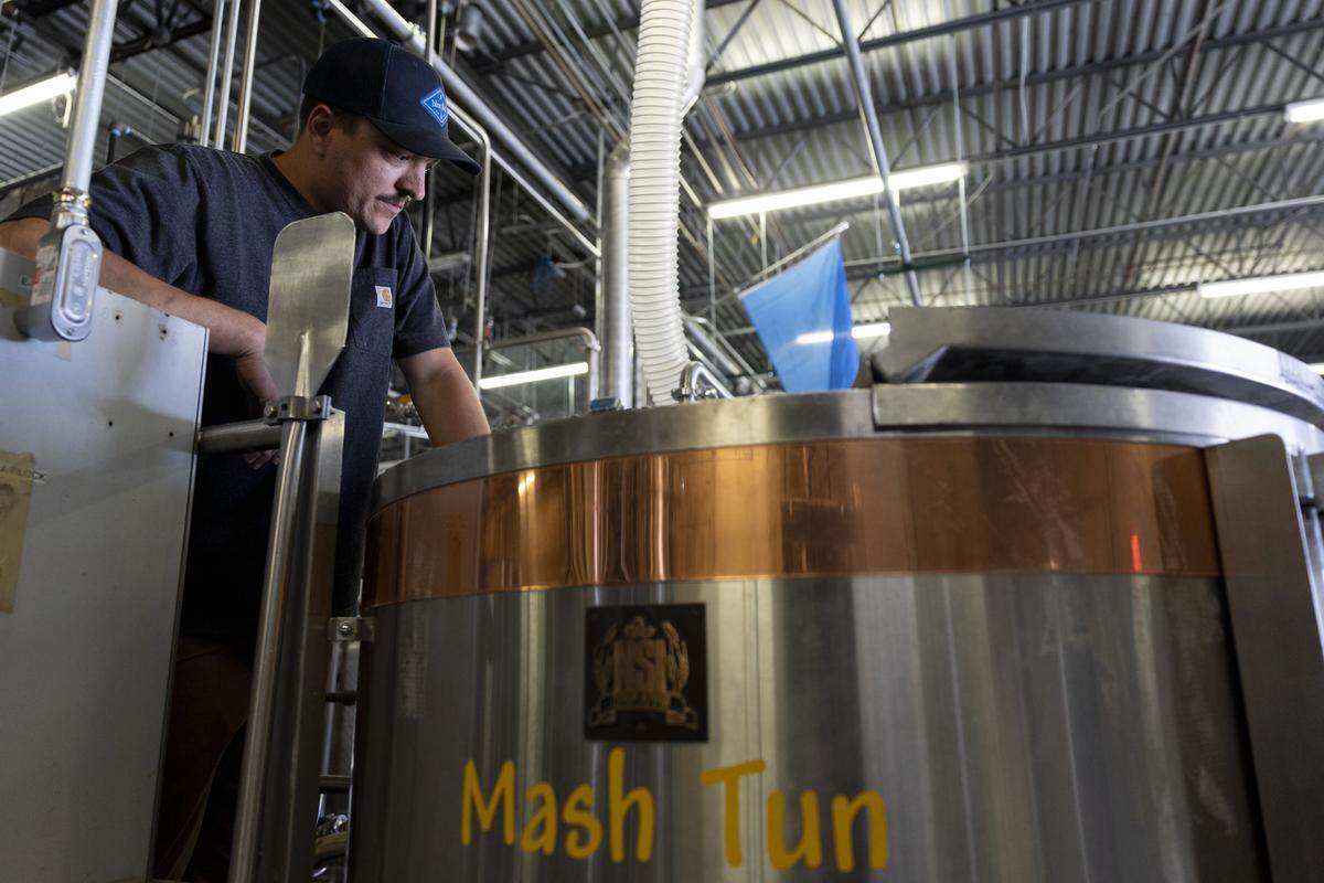 Head brewer Dakota Bartee Businesses checks the mash tun at Blue Flag Distillery on Thursday, May 7, 2026 in Fort Worth, Texas. Blue Flag Distillery produces American single malt whiskey, gin, beer and other spirits.