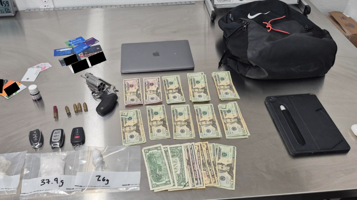 The Bedford Police Department released a photo showing stolen items from a string of car burglaries, along with drugs, a gun, cash and IDs that were found in a search of the suspects’ hotel room in Fort Worth.