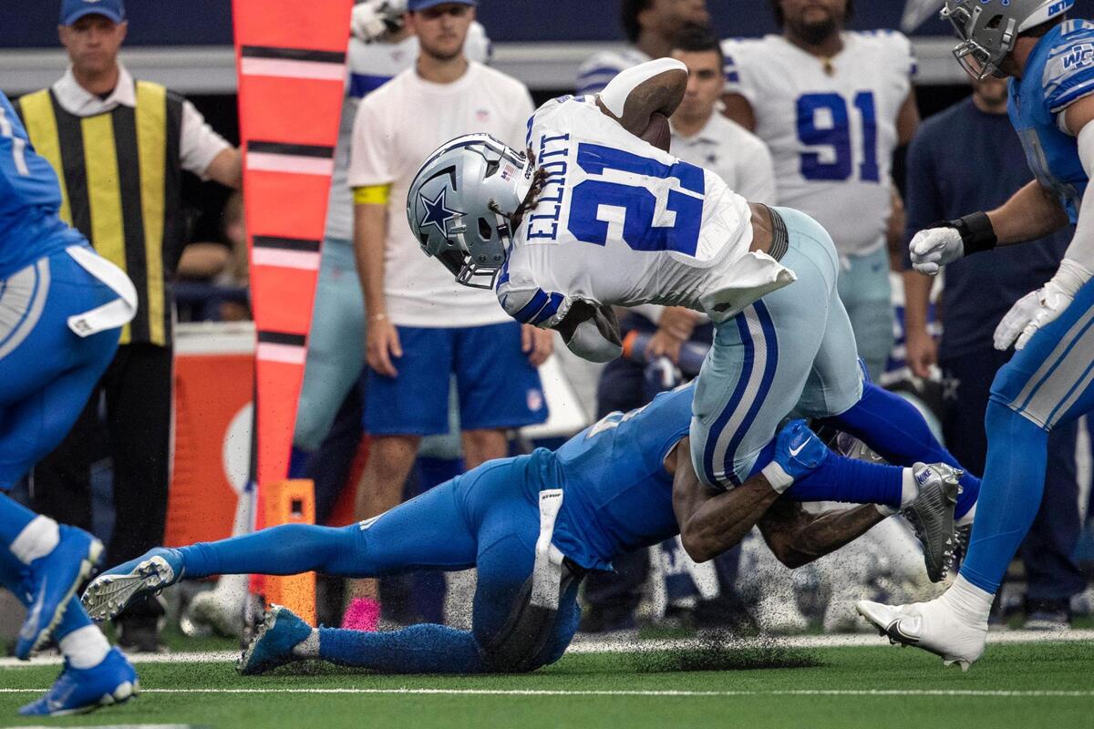 Dallas Cowboys running back Ezekiel Elliott completes a pass before being tackled during their game against the Detroit Lions at the AT&T Stadium in Arlington on Sunday, Oct. 23, 2022.